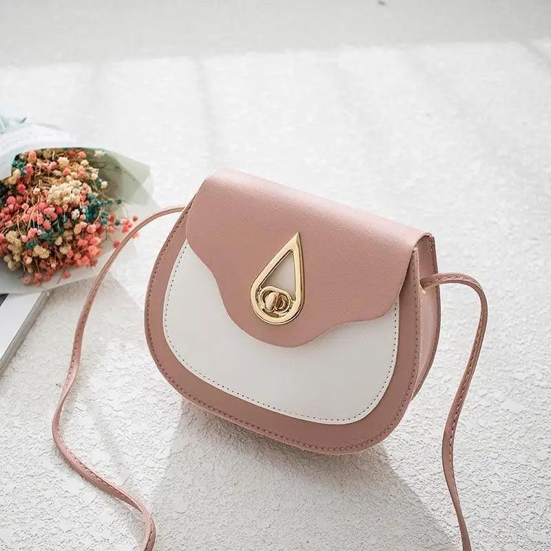 Fashionable rounded PU leather crossbody bag with tassel detailing and multi-zip compartments