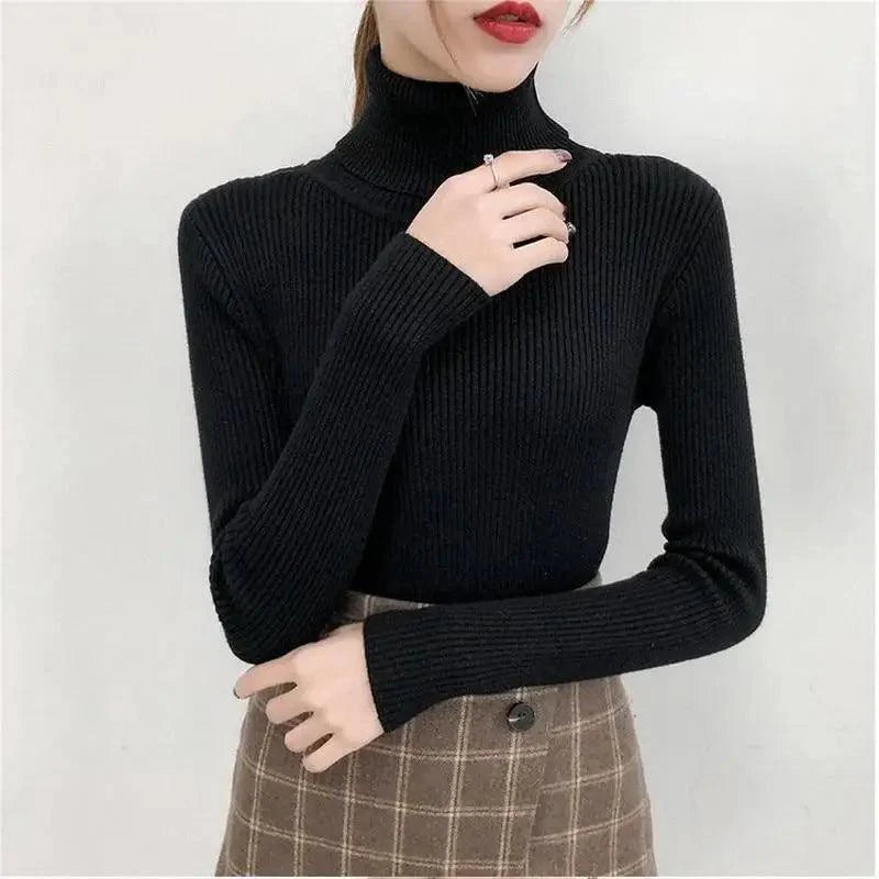 Close up of a woman wearing a soft, pink turtleneck sweater with a ribbed neckline.