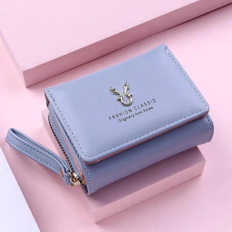 Small elegant card holder and coin purse in pale-pink leather-like material.