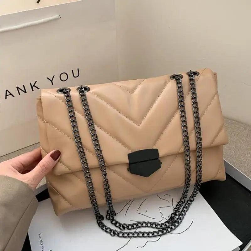 A stylish quilted black PU leather crossbody bag with a gold-tone chain strap and lock closure.