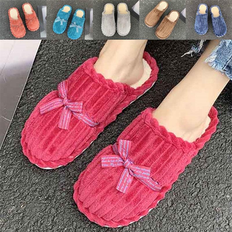 A pair of cozy, minimalist memory foam house slippers in a neutral solid color for bedroom lounging.