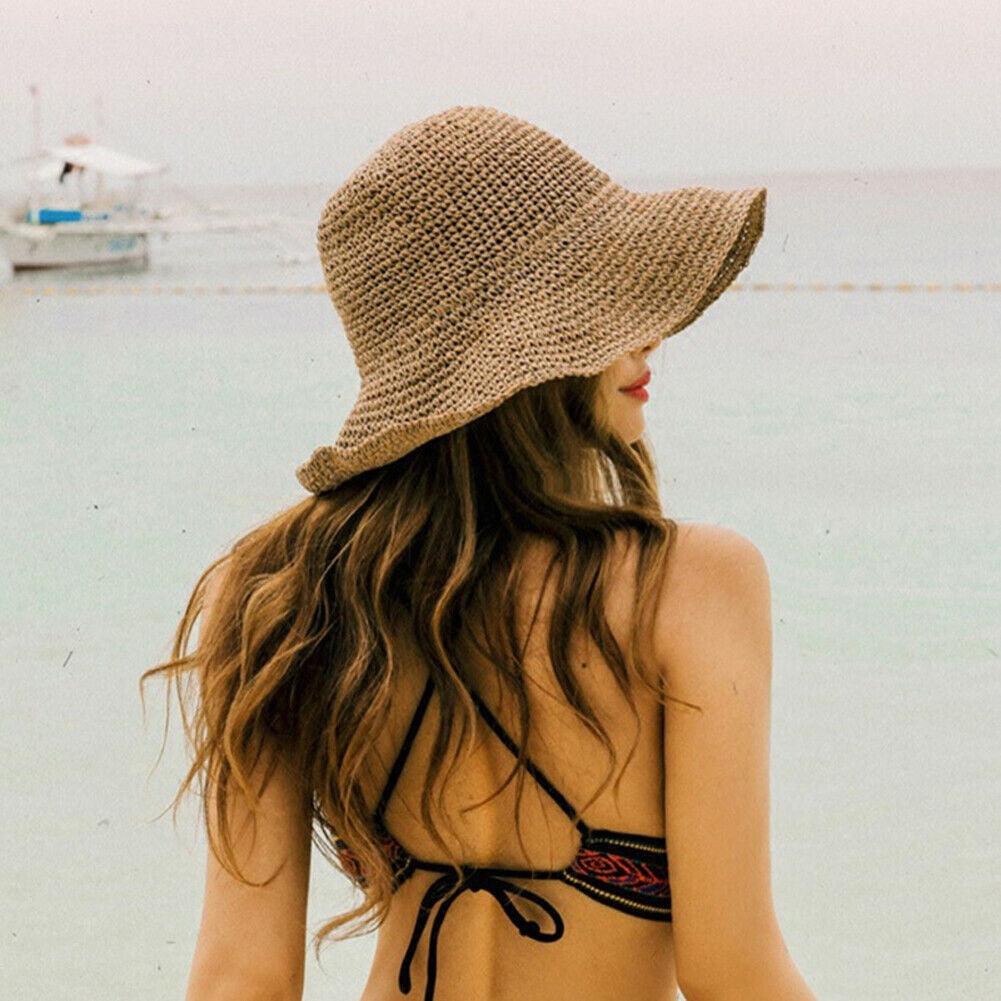 Trendy women's wide brim straw bucket hat for summer sun protection and travel