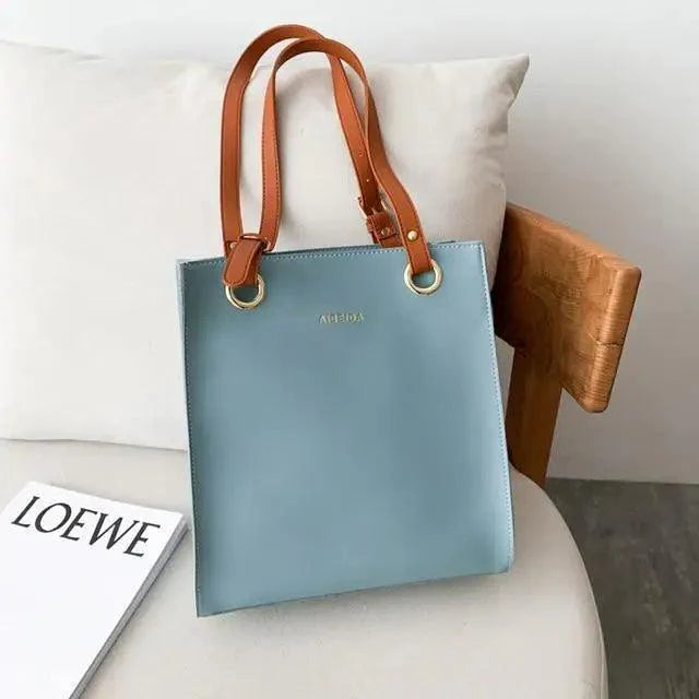 Large retro-style leather shoulder bag with long handles and a spacious interior