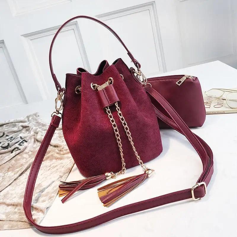 Mini bucket crossbody bag with tassel detail and drawstring closure