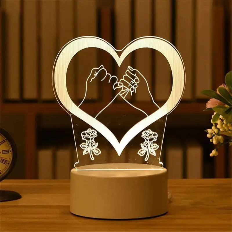 Heart-shaped 3D balloon LED night light on a wooden table base.