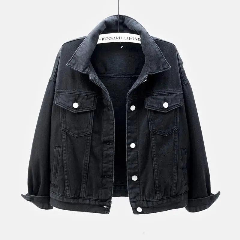 A woman wearing a loose-fit, soft denim trucker jacket in a casual spring-autumn style.