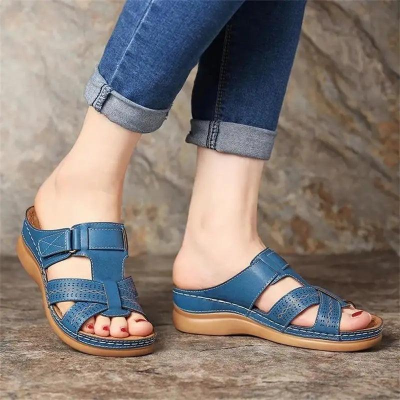 Women wearing comfortable buckle strap heeled sandals in a summer outdoor setting