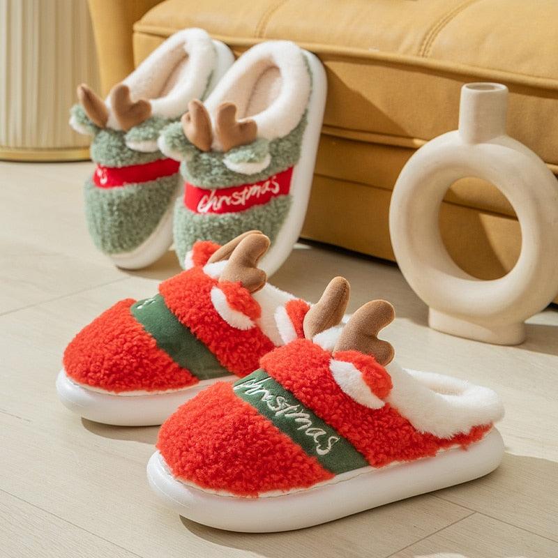 A pair of plush Christmas deer slippers in festive colors with a thick platform sole, perfect for indoor winter comfort.