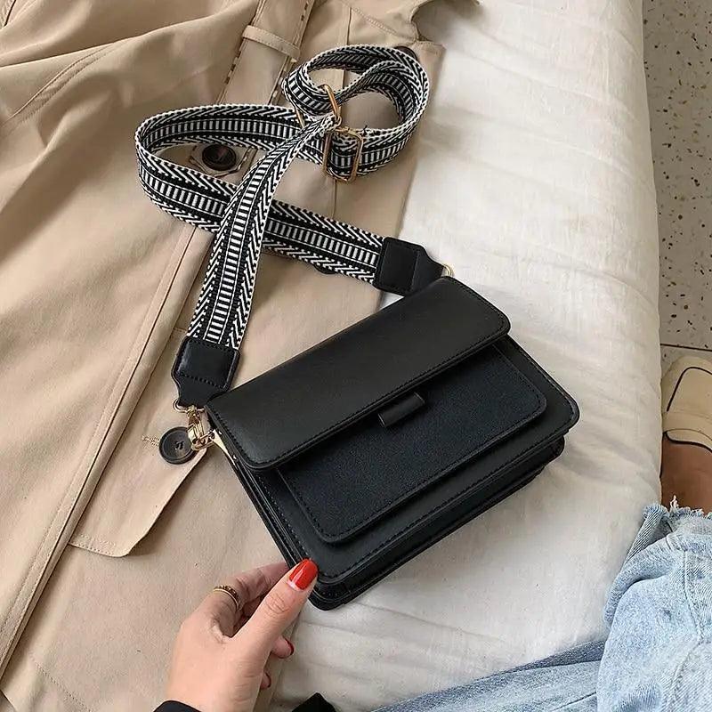 Small square geometric pattern crossbody bag with a wide adjustable shoulder strap