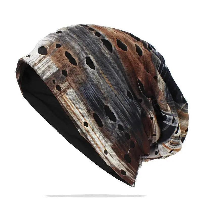 Unisex slouchy knit beanie in black and multi-color, displayed in a streetwear grunge style.