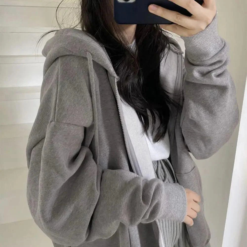 Woman wearing an oversized loose long-sleeve pink hoodie for casual streetwear