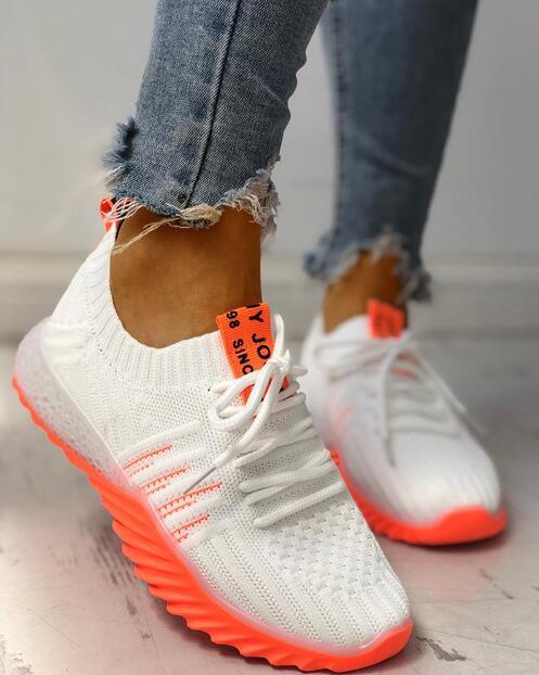 Women's modern platform slip-on mesh sneakers with neon-colored outsoles and solid knit uppers.