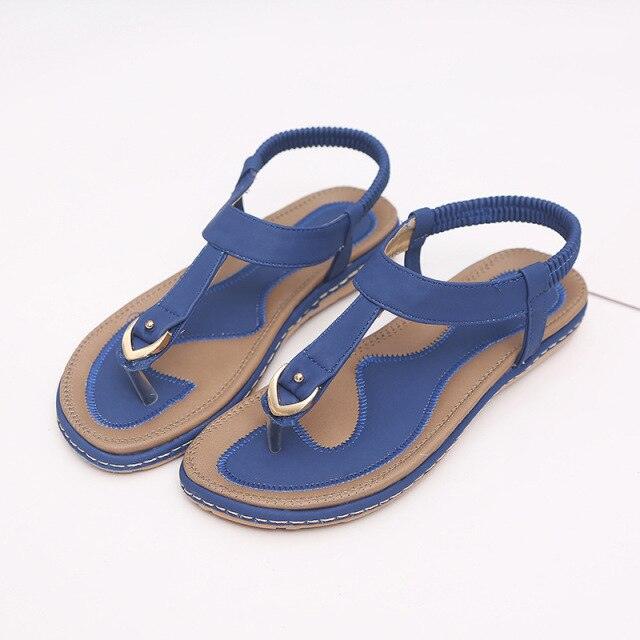 Women's T-strap flat sandals with elastic ankle strap and rubber sole for beach wear