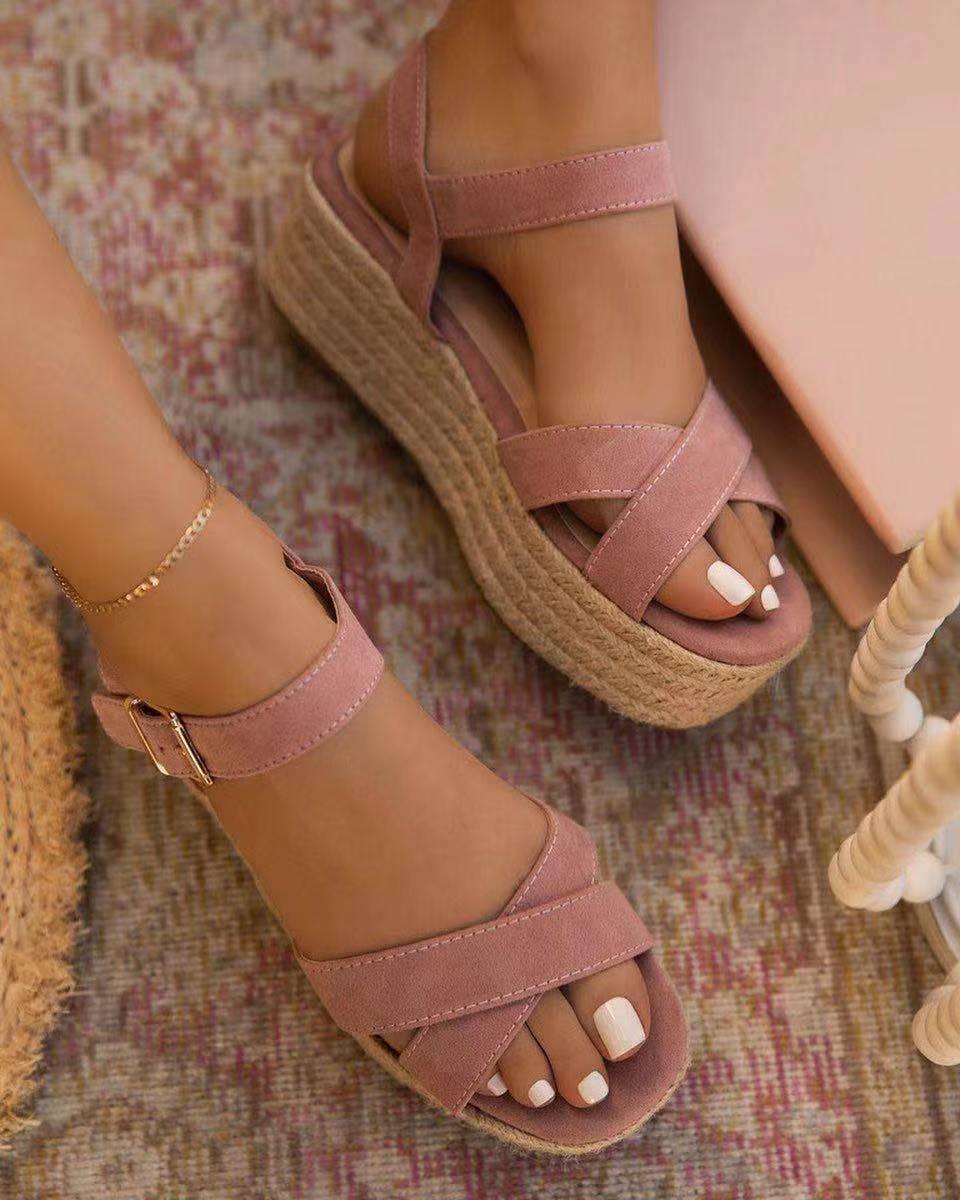 A pair of women's platform summer sandals with an adjustable ankle strap and open-toe design.
