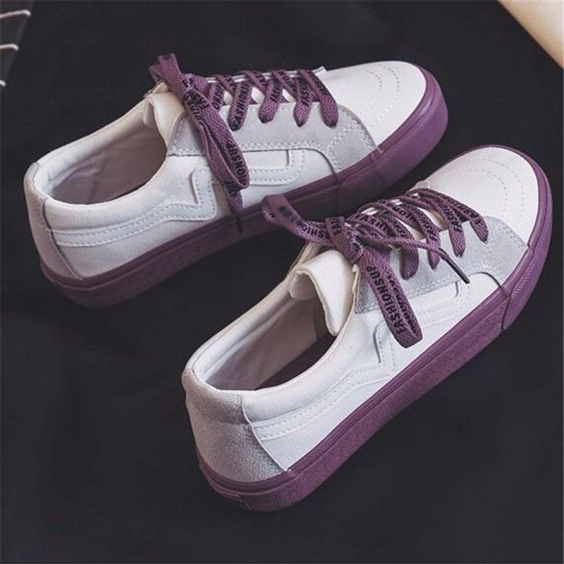 Women's white low-top platform canvas sneakers with lace-up closure.