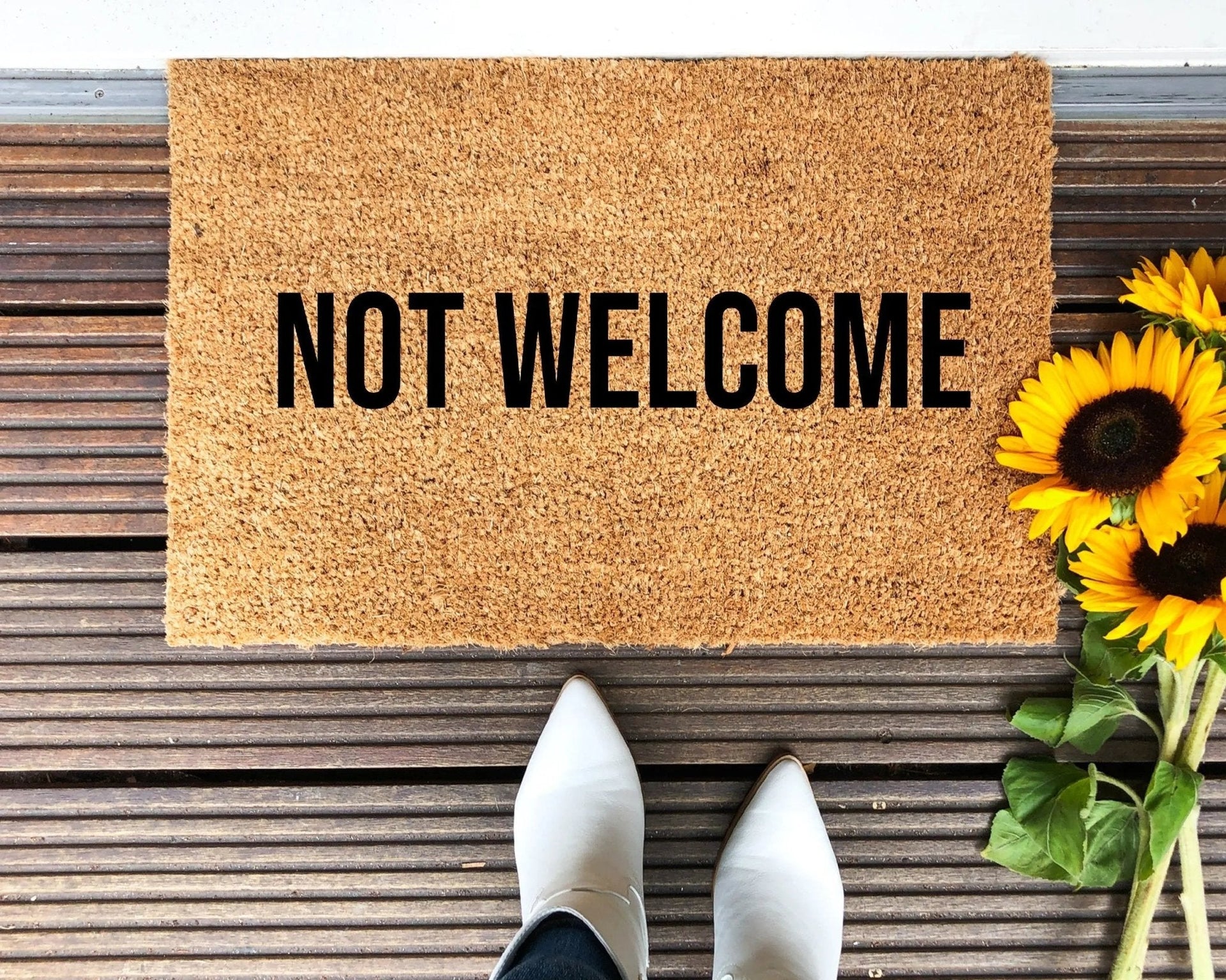 Minimalist Not Welcome doormat in brown natural coir with black typography