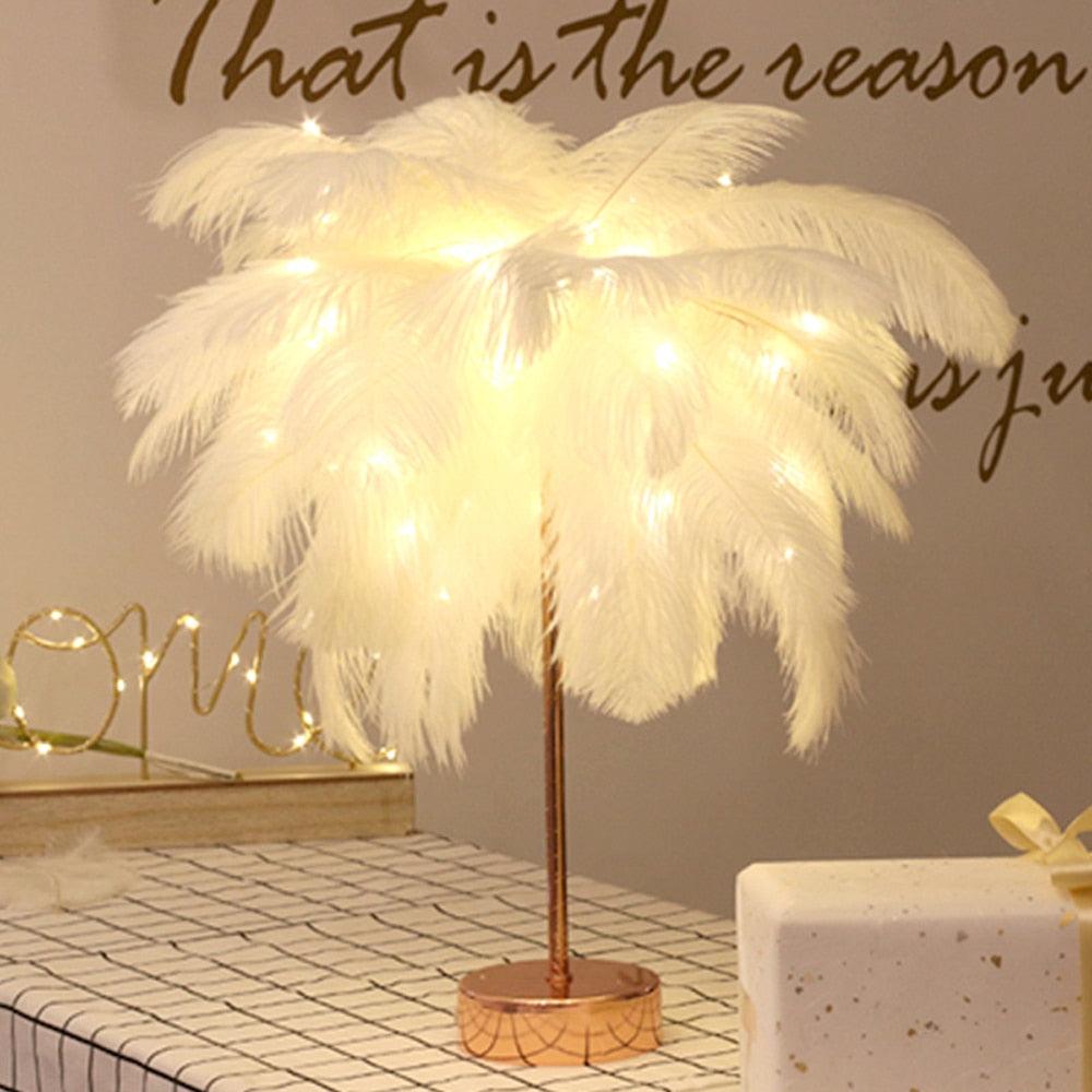 Glamorous feather table lamp with polished nickel base on a bedside table