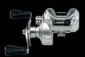 Silver Novus baitcasting reel showing side profile with 7-bearing system label