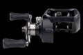 Novus Pro black low-profile casting reel showing side adjustment dial and handle