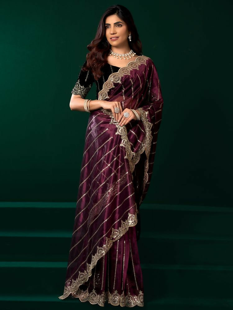 Purple Net party wear saree paired with a contrast black velvet blouse