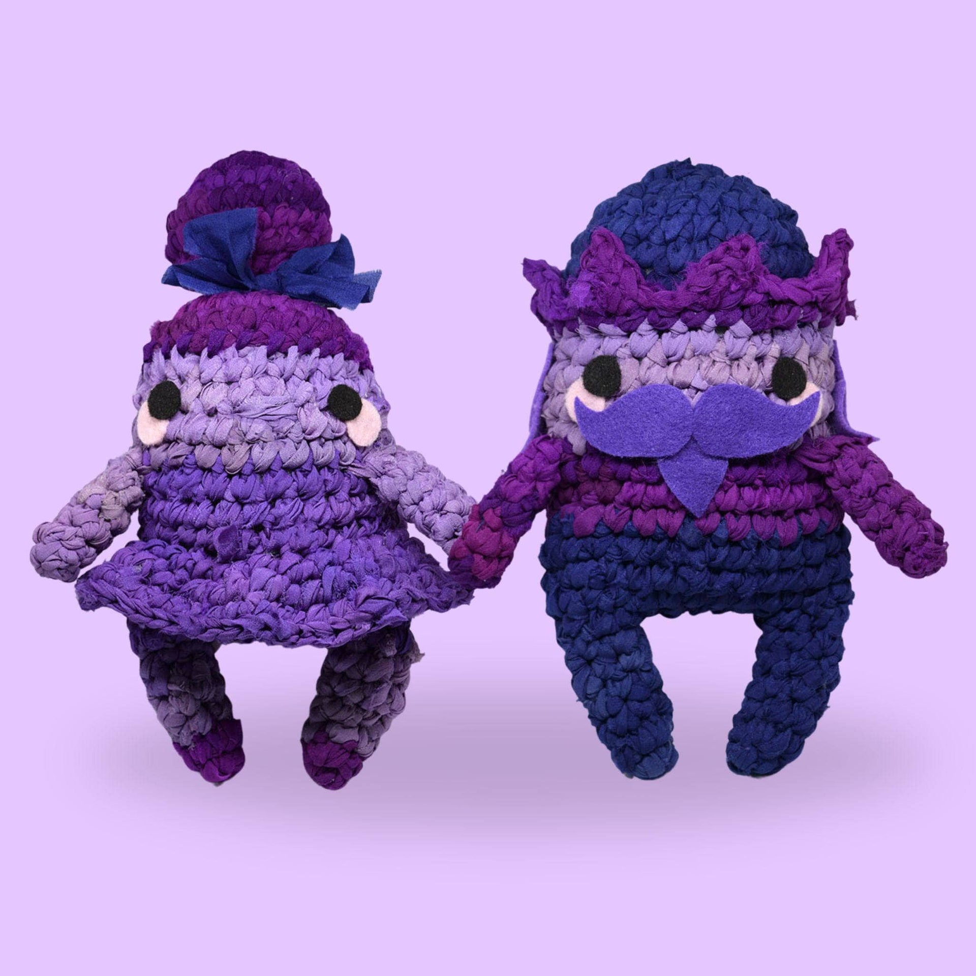 Amigurumi Nutcracker and Sugar Plum Fairy dolls in purple monochrome, handmade from a crochet craft kit.