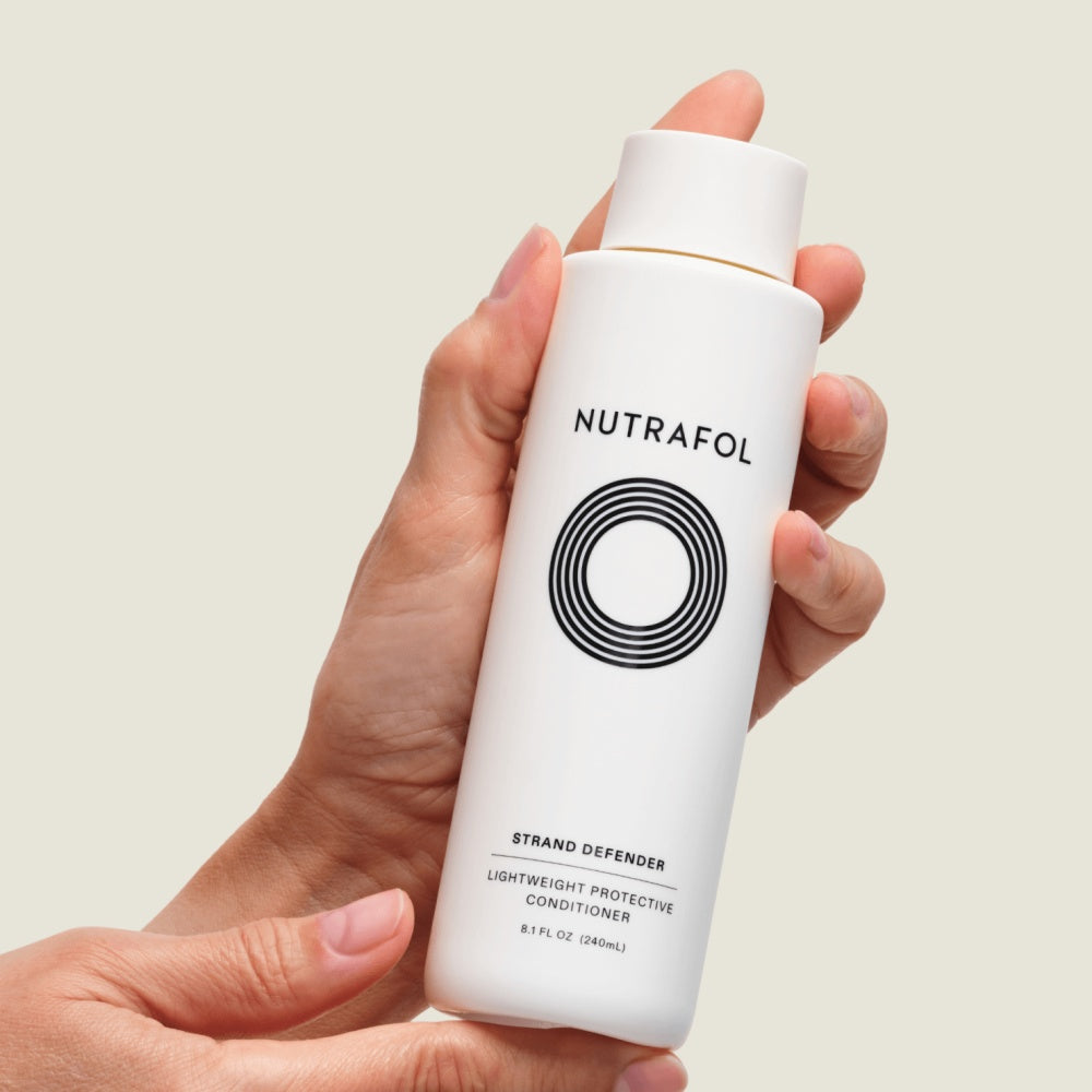 Nutrafol Strand Defender Lightweight Protective Conditioner white bottle