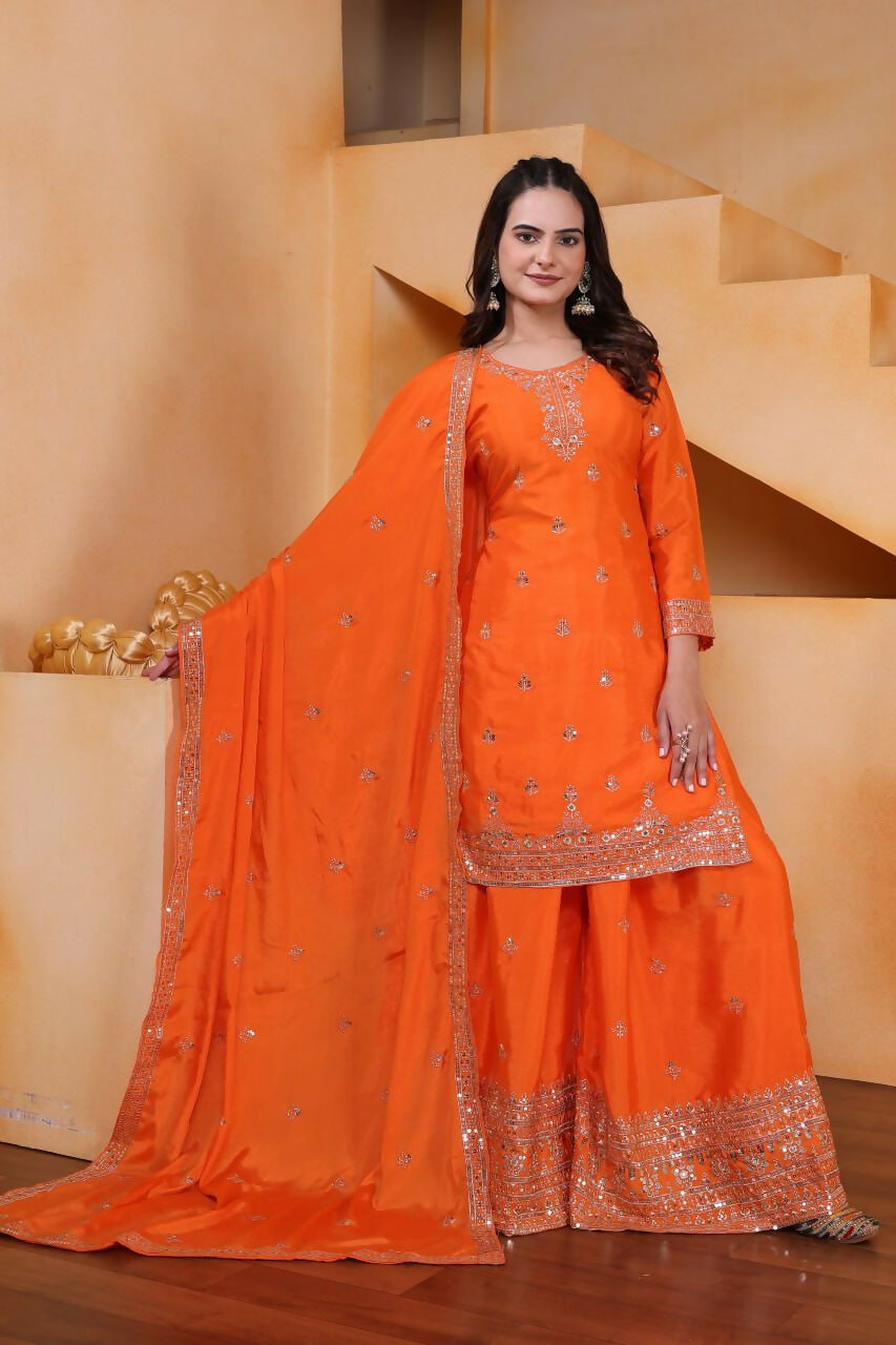 Vibrant orange silk embroidered kurti with sharara set for festive celebrations