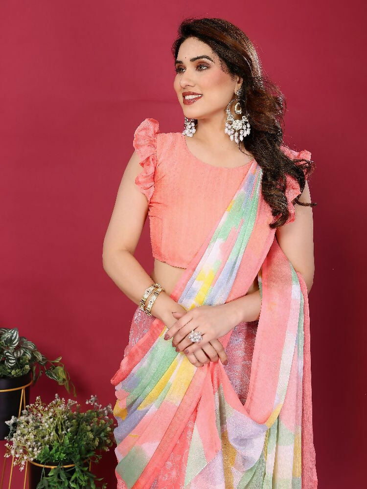 Woman wearing a Peach Moss Chiffon printed saree with a matching blouse.