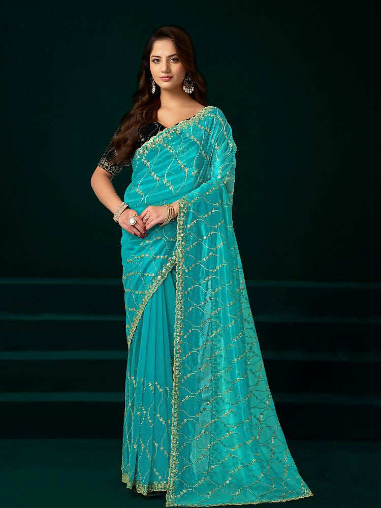 Turquoise net saree with a contrasting black velvet blouse, perfect for party wear.