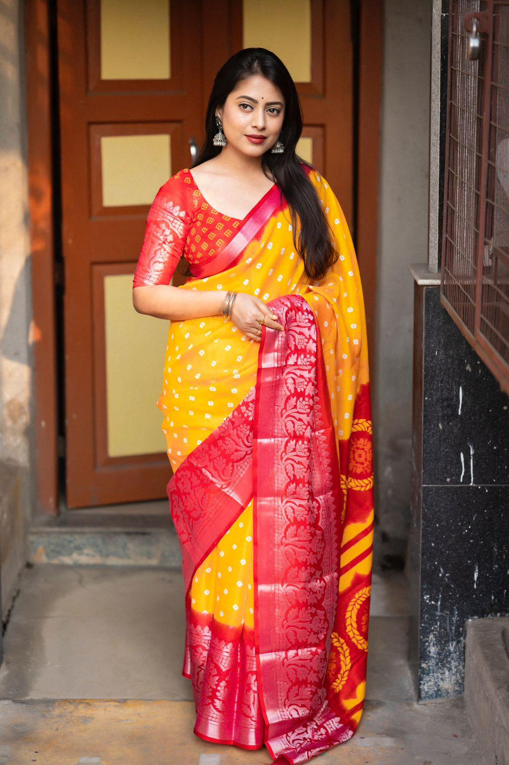 Yellow jute silk saree with allover bandez print and detailed cut broaso border