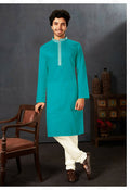 Baby boy wearing a firozi cotton kurta with off-white art silk pyjamas for a festive occasion.