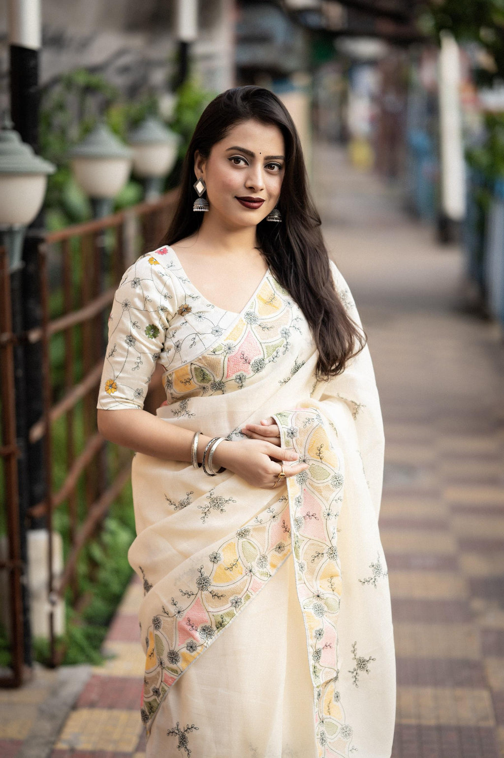 Cream pure linen saree with ethnic pencil stitch embroidery and matching embroidered phantom silk blouse.