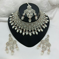 Elegant cream colored stone work necklace set with matching earrings and head tikka for ethnic wear.