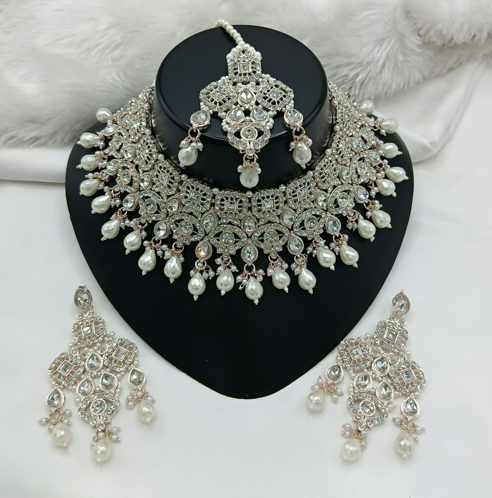 Elegant cream colored stone work necklace set with matching earrings and head tikka for ethnic wear.