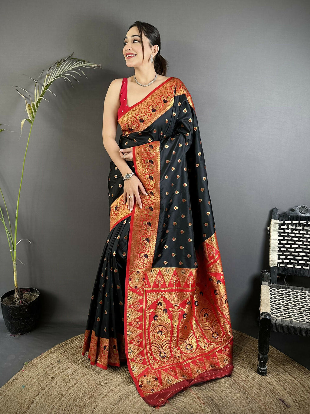 A black soft silk Banarasi saree with intricate motifs and a maroon butti blouse.