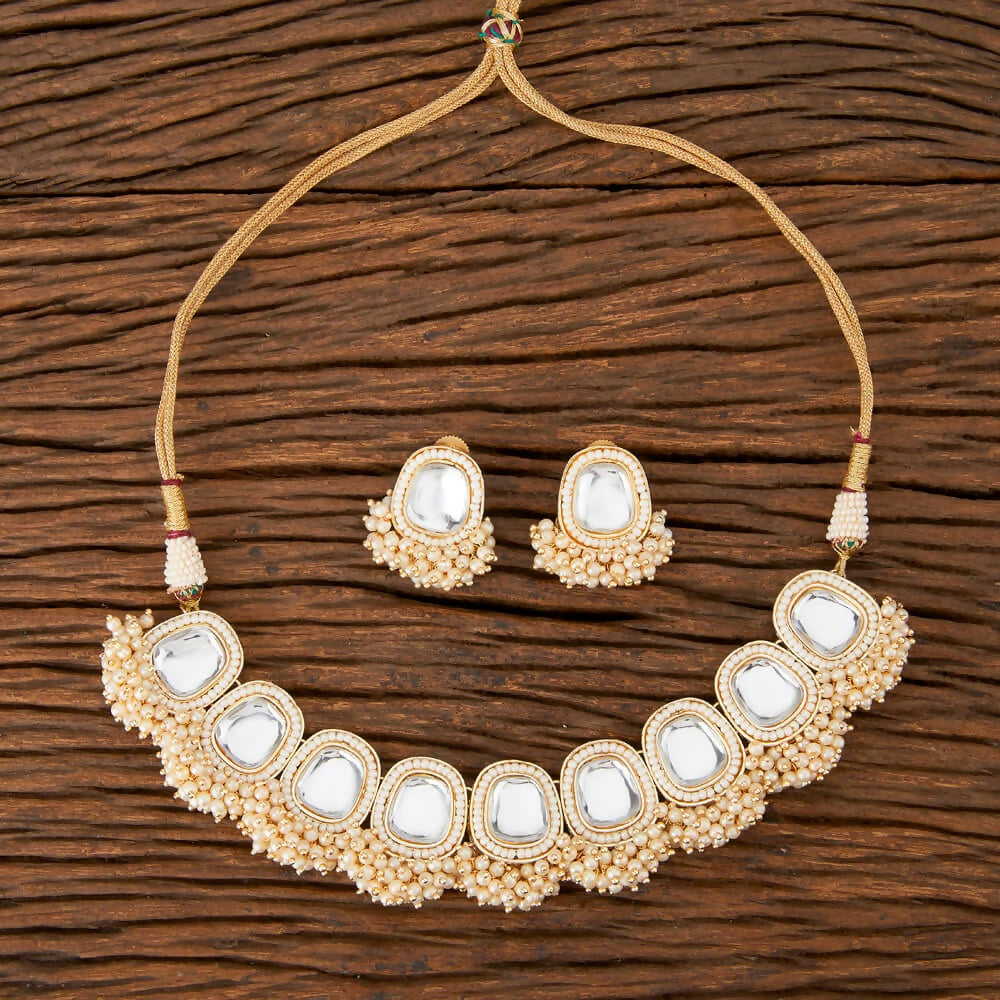 Classy golden and white Kundan pearl necklace set with onyx accents
