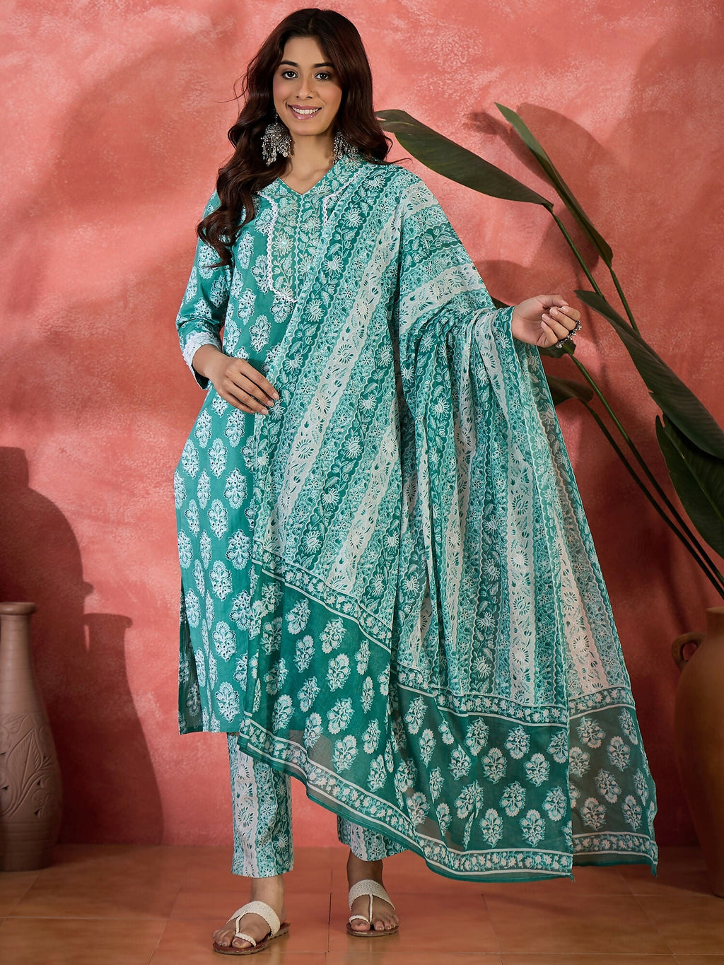 A woman wearing a teal printed pure cotton kurta set with elegant patterns