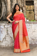 A luxurious red pure Katan handloom Banarasi silk saree with intricate traditional weaving.