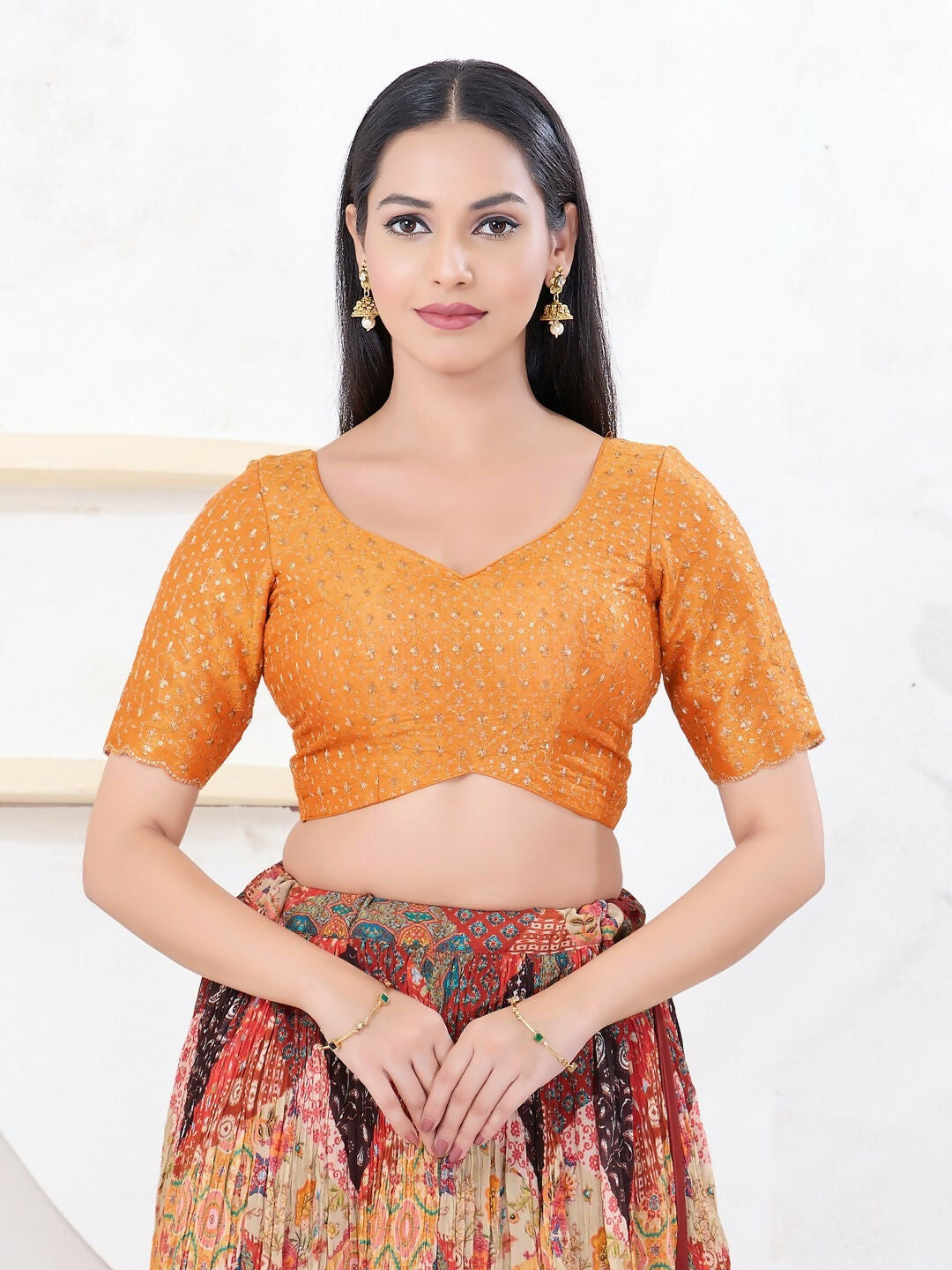 Orange tissue fabric blouse with a sweetheart neckline and elbow-length sleeves.