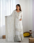 White silk kurta set with ornate zari, sequence, and thread embroidery