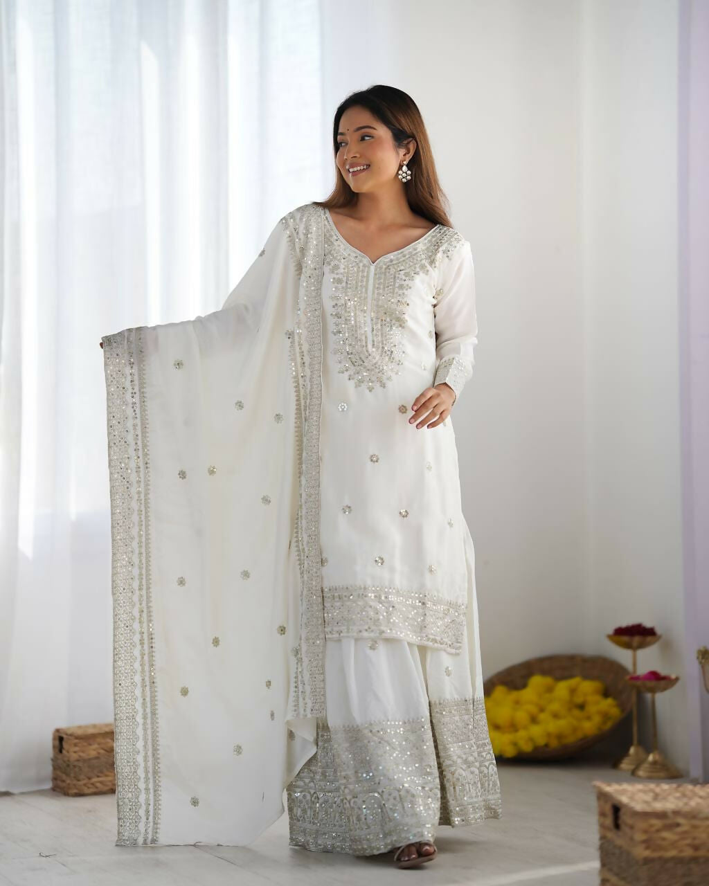 White silk kurta set with ornate zari, sequence, and thread embroidery