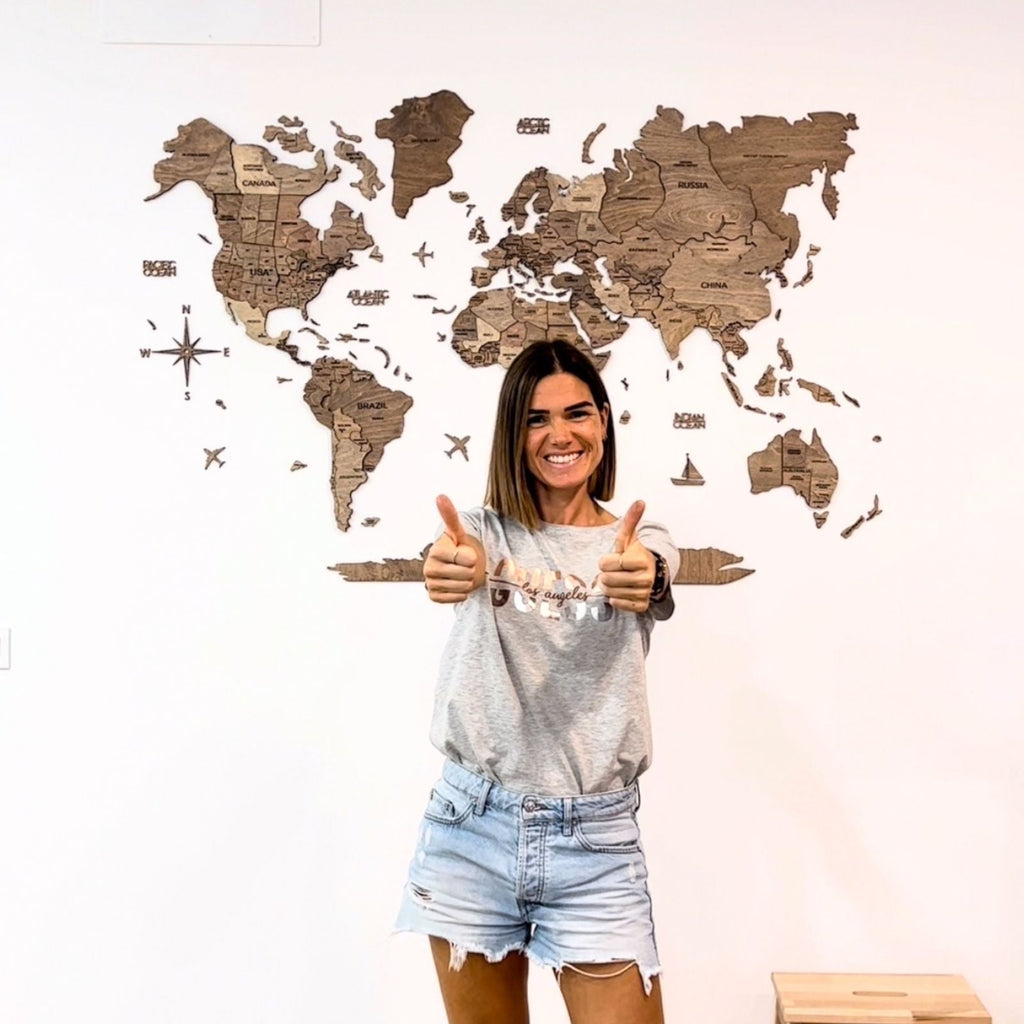Minimalist wooden world map wall art featuring brown wood textures in an office setting.