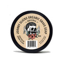 Round container of Johnny Slicks organic shaving soap with skull graphic