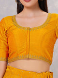 Close-up of mustard silk stitched blouse with intricate embroidery and round neck