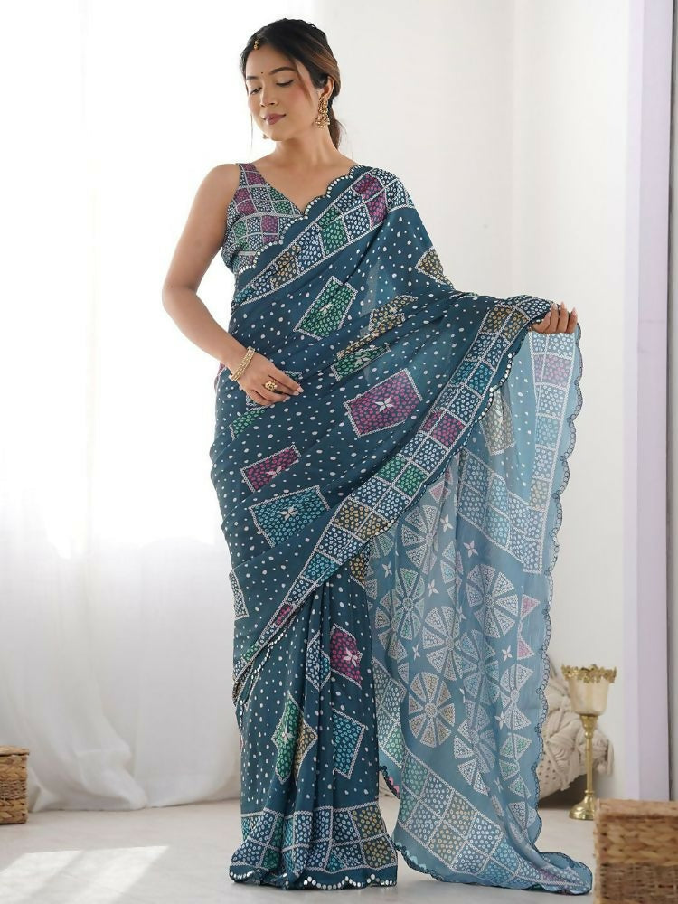 Teal georgette saree featuring geometric digital prints and delicate mirror work embroidery.