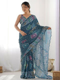 Teal georgette saree featuring geometric digital prints and delicate mirror work embroidery.