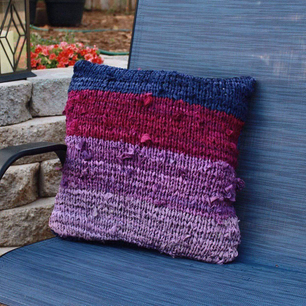 Finished Ombre Chiffon Pillow displayed on a couch, showing the gradient knit pattern.