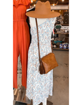 Model wearing a one-shoulder midi dress with a unique graphic print pattern.