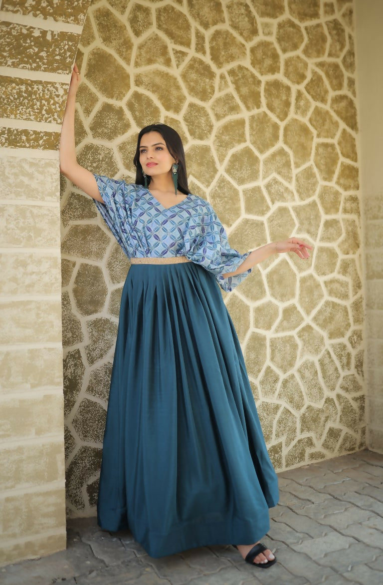 Woman wearing a teal floor-length Chinon Anarkali dress with sequin details and printed patterns