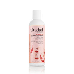 Bottle of Ouidad Advanced Climate Control Defrizzing Conditioner for curly hair